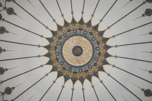 Pale mosque ceiling with fine navy lines radiating from a central ornamental medallion
